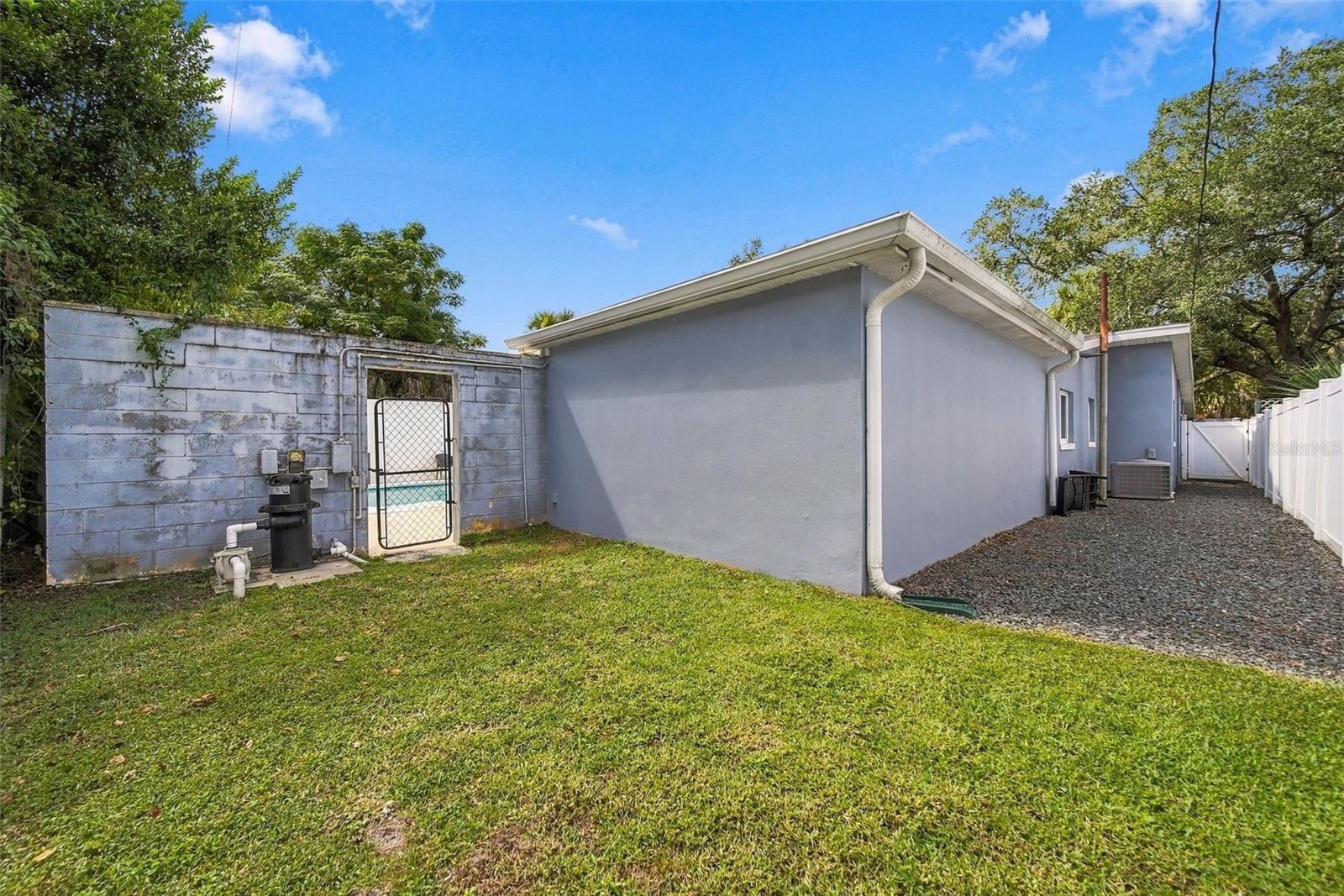 The yard extends beyond the pool area