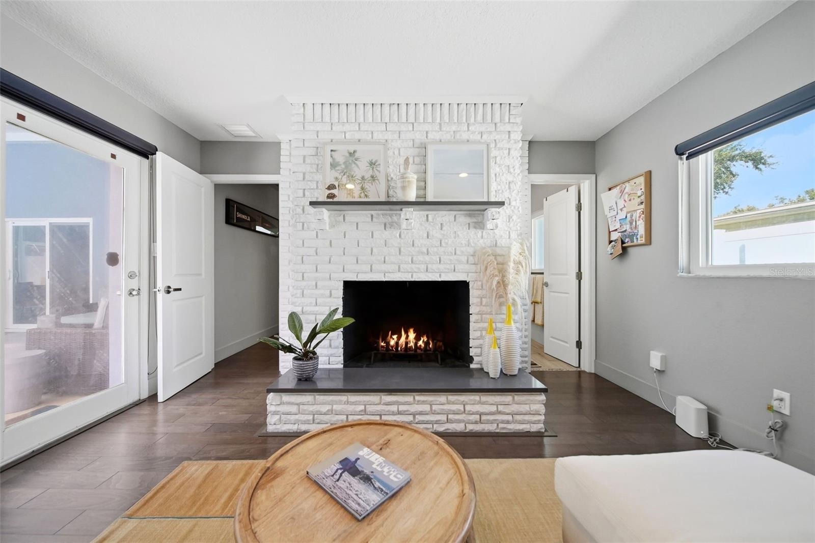 Primary suite with wood-burning fireplace and sliders to the pool