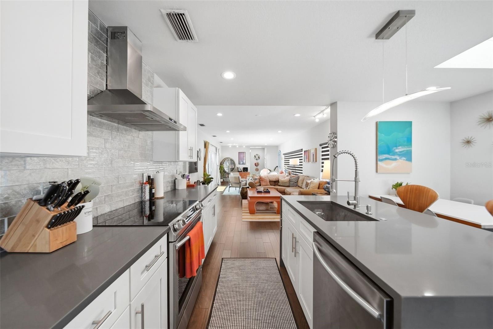 15 x 17 totally renovated kitchen with shaker cabinets, stainless appliances and vent hood. Counters and island are quartz.