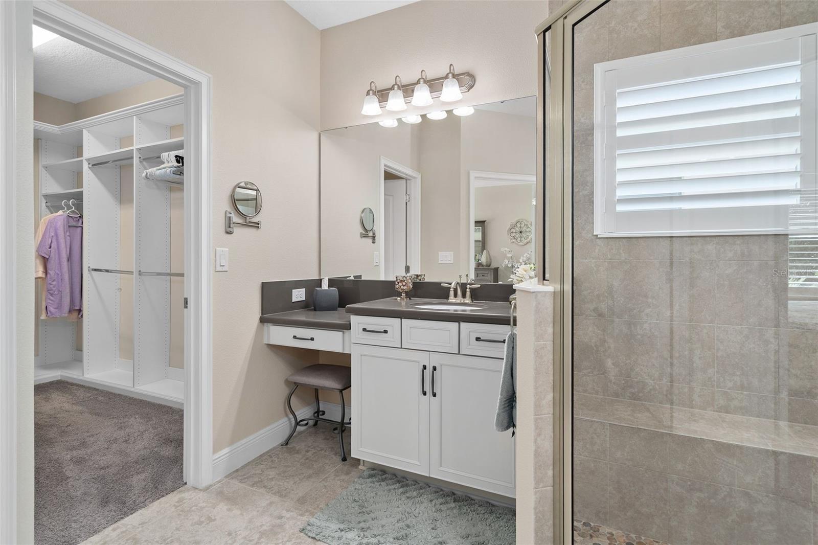 Primary En-Suite offering Comfort Height split vanities, Quartz Counters and a custom Organized Walk-in closet.