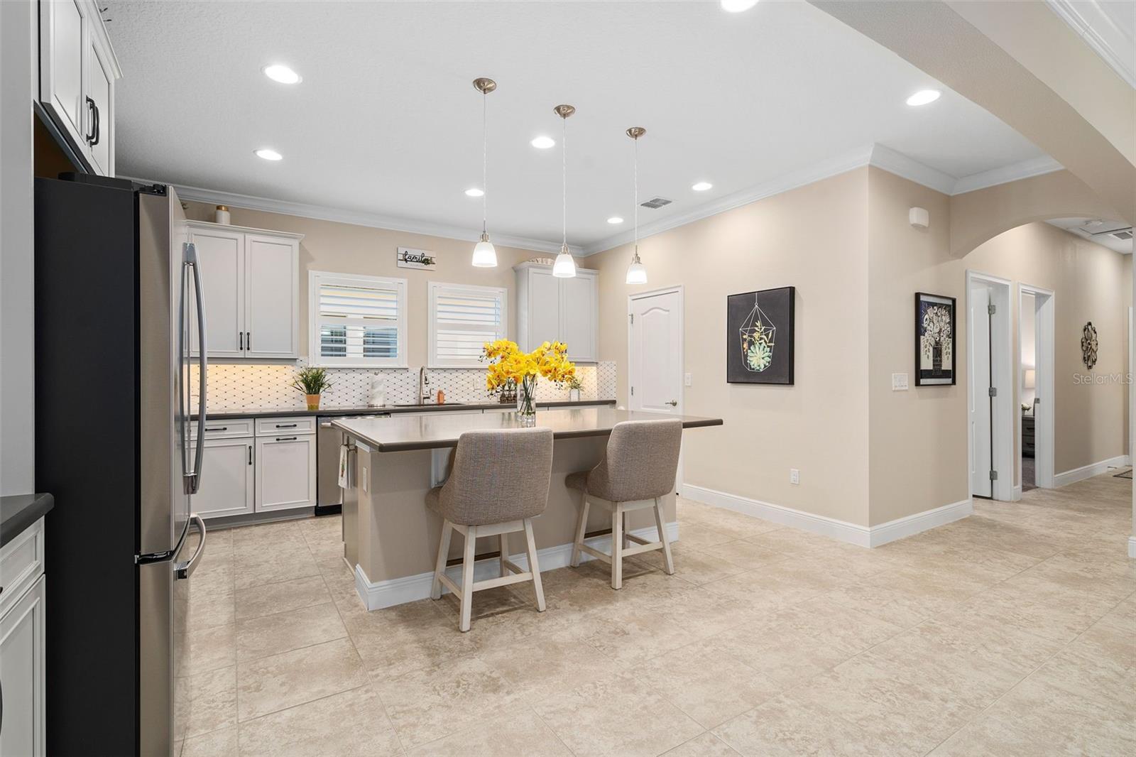 Upgraded Solid Wood 42" Cabinetry with Under Cabinet Lighting and a Large Walk-in pantry grace the Kitchen