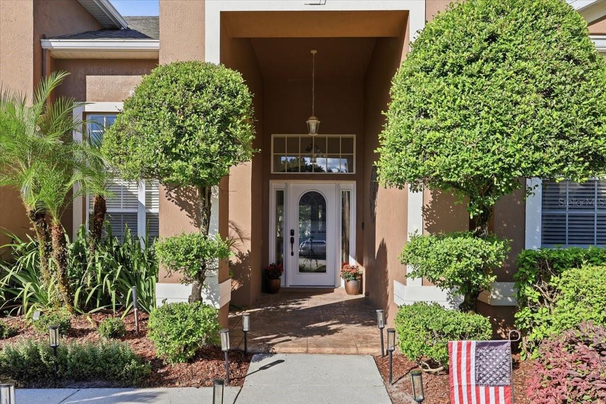 Manicured landscaping, covered front entry.