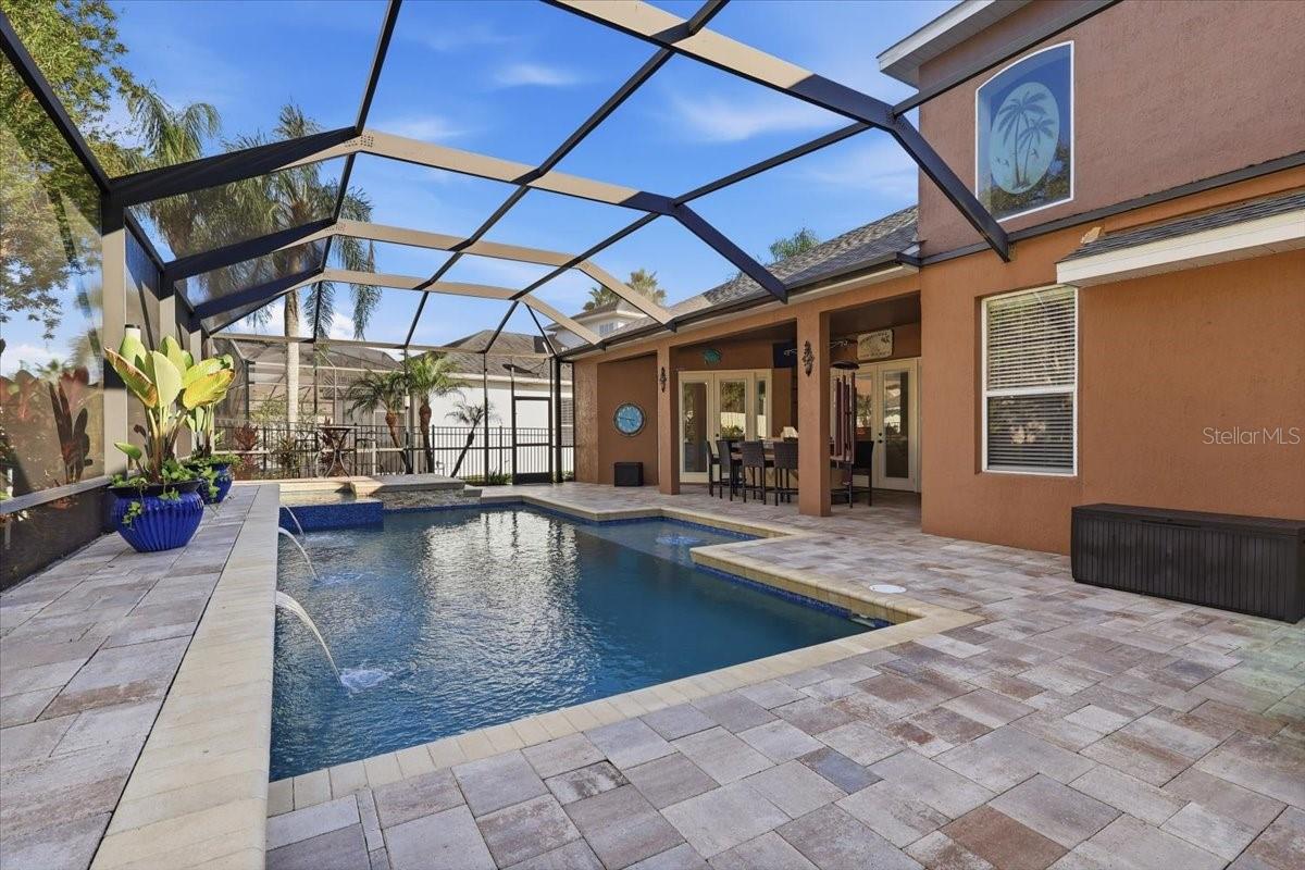 Covered lanai overlooks the private screened pool.