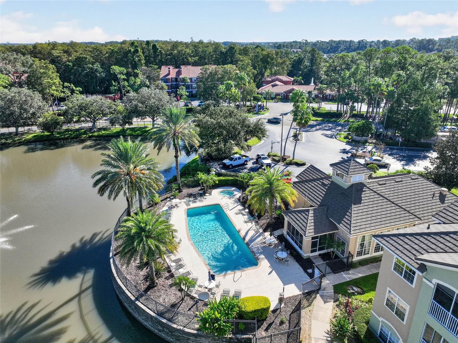 Aerial of clubhouse, community pool and pond