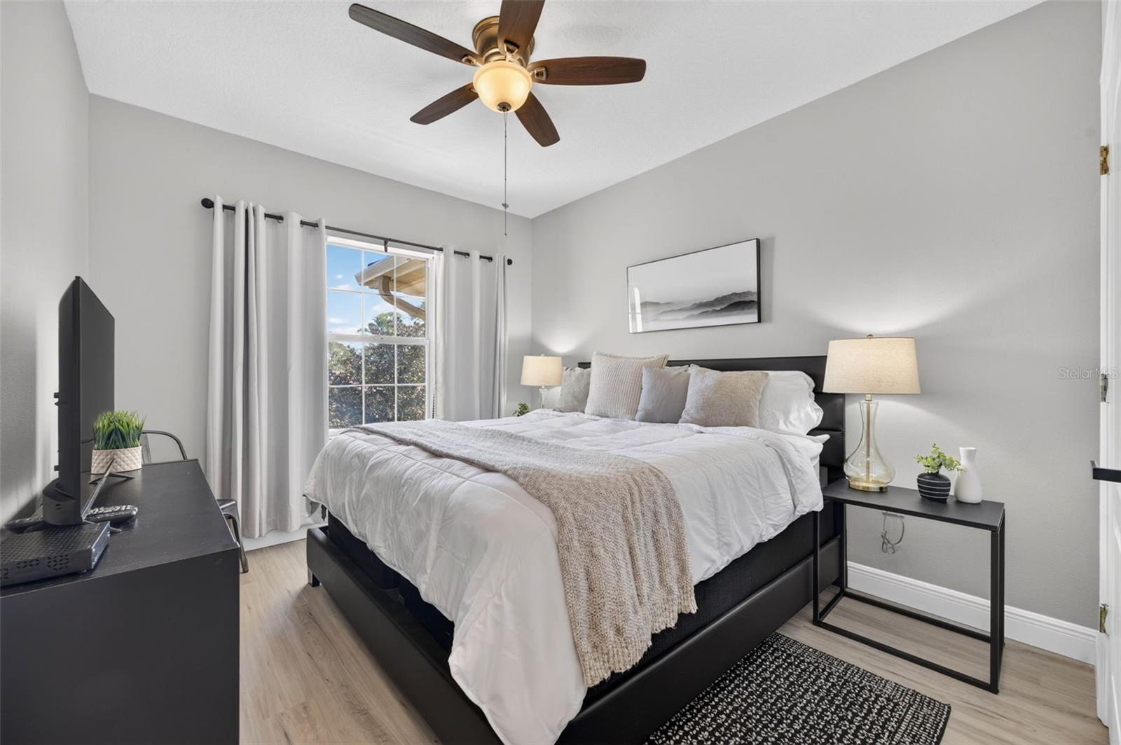 Second bedroom with ceiling fan and walk-in closet