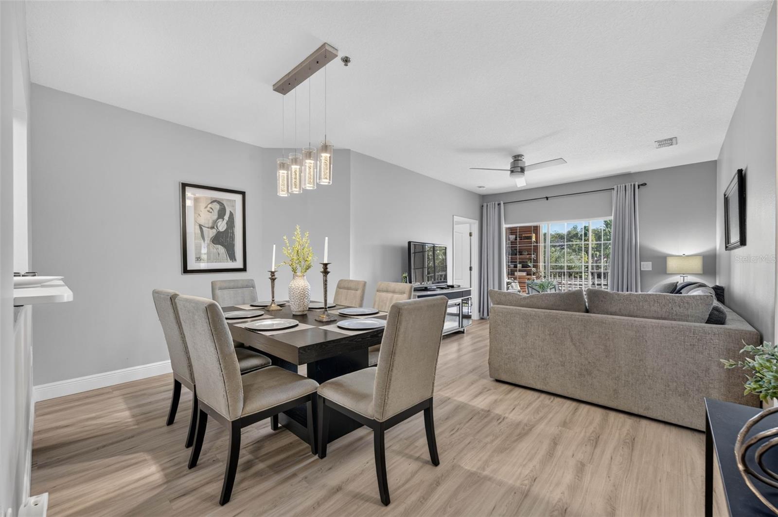 Open dining and living room with ceiling fan