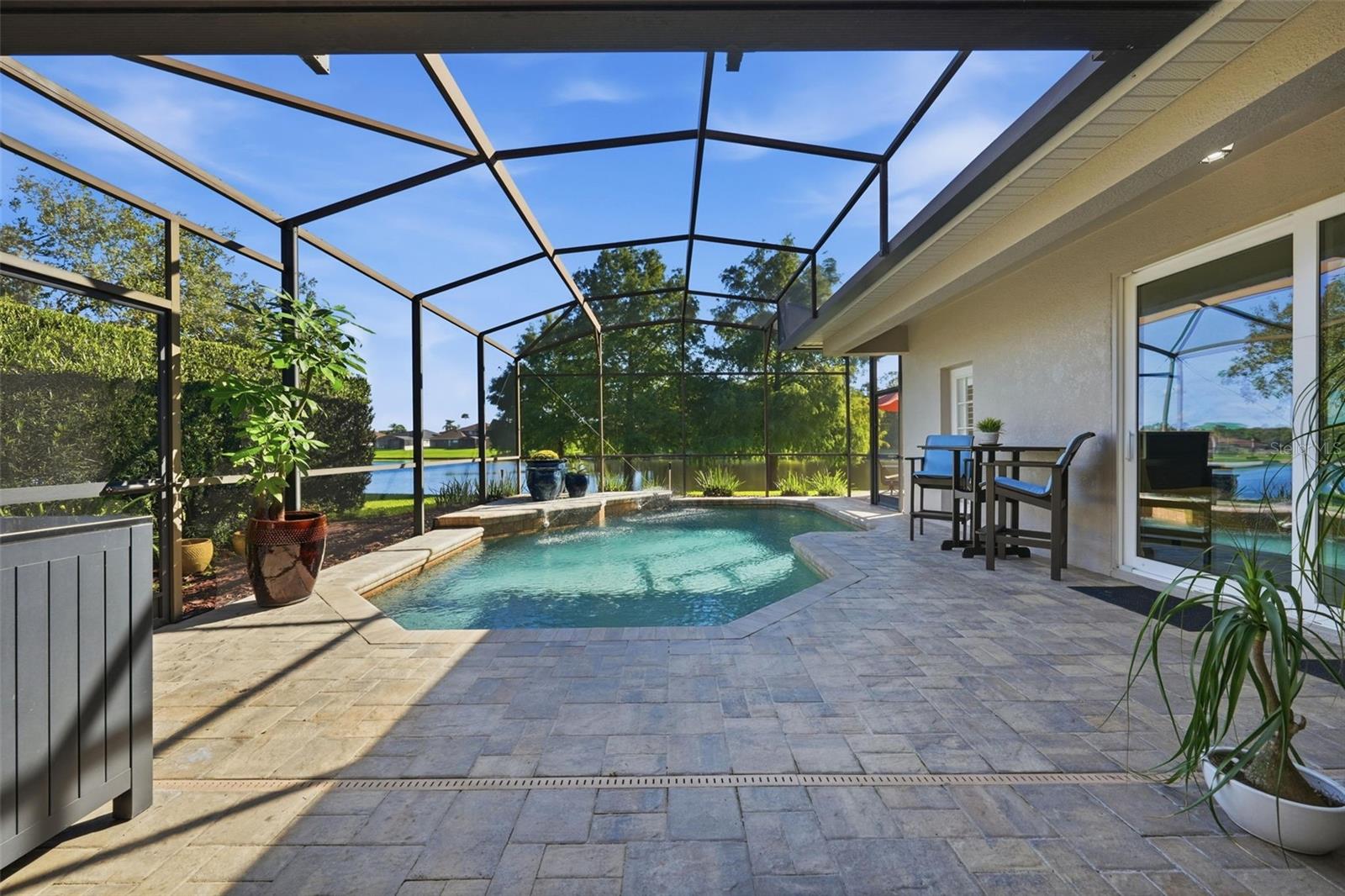 VIEW OF THE POOL, POND, CYPRESS TREES AND CONSERVATION. NO REAR NEIGHBORS!