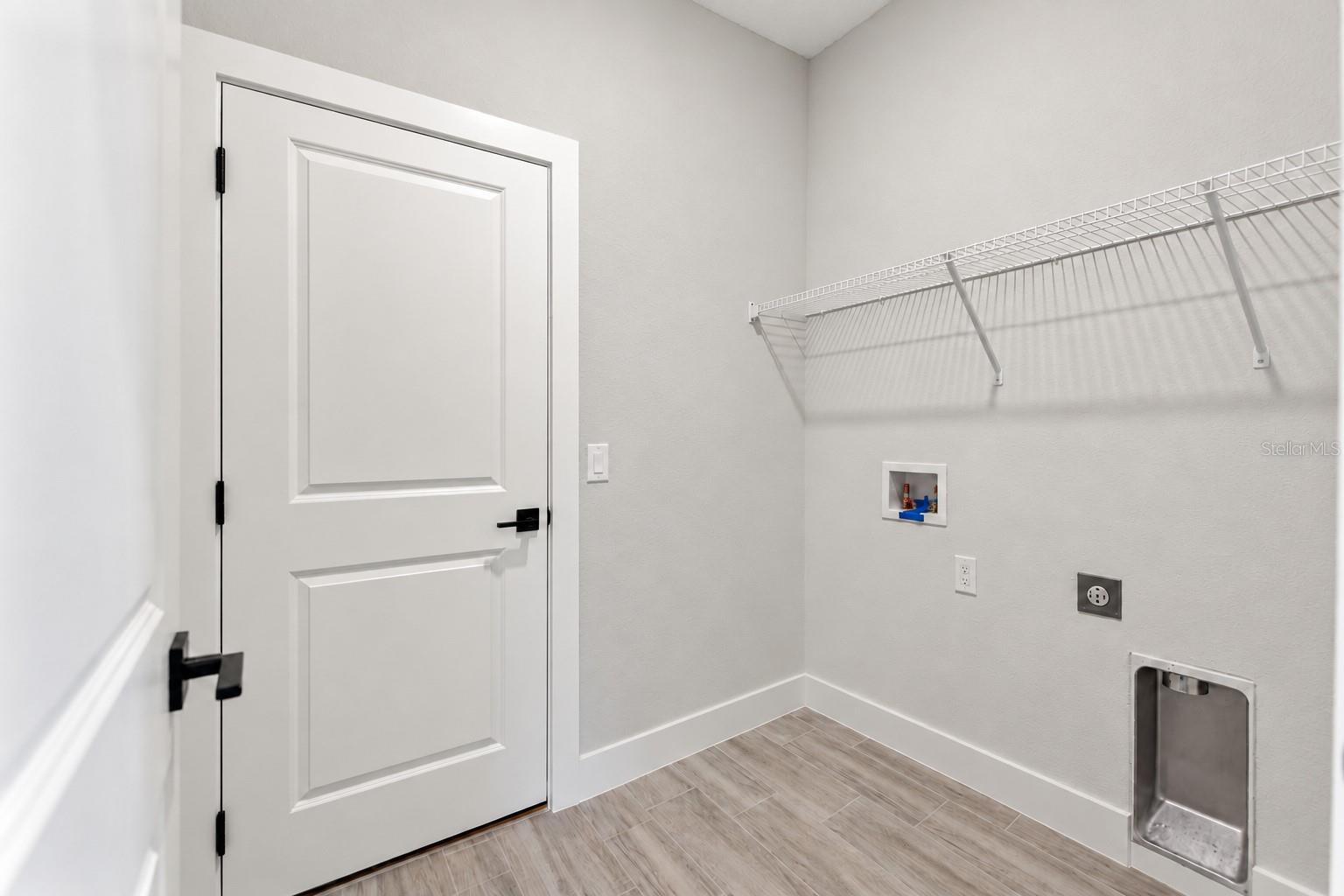 Laundry room. Digitally edited model/property composite.