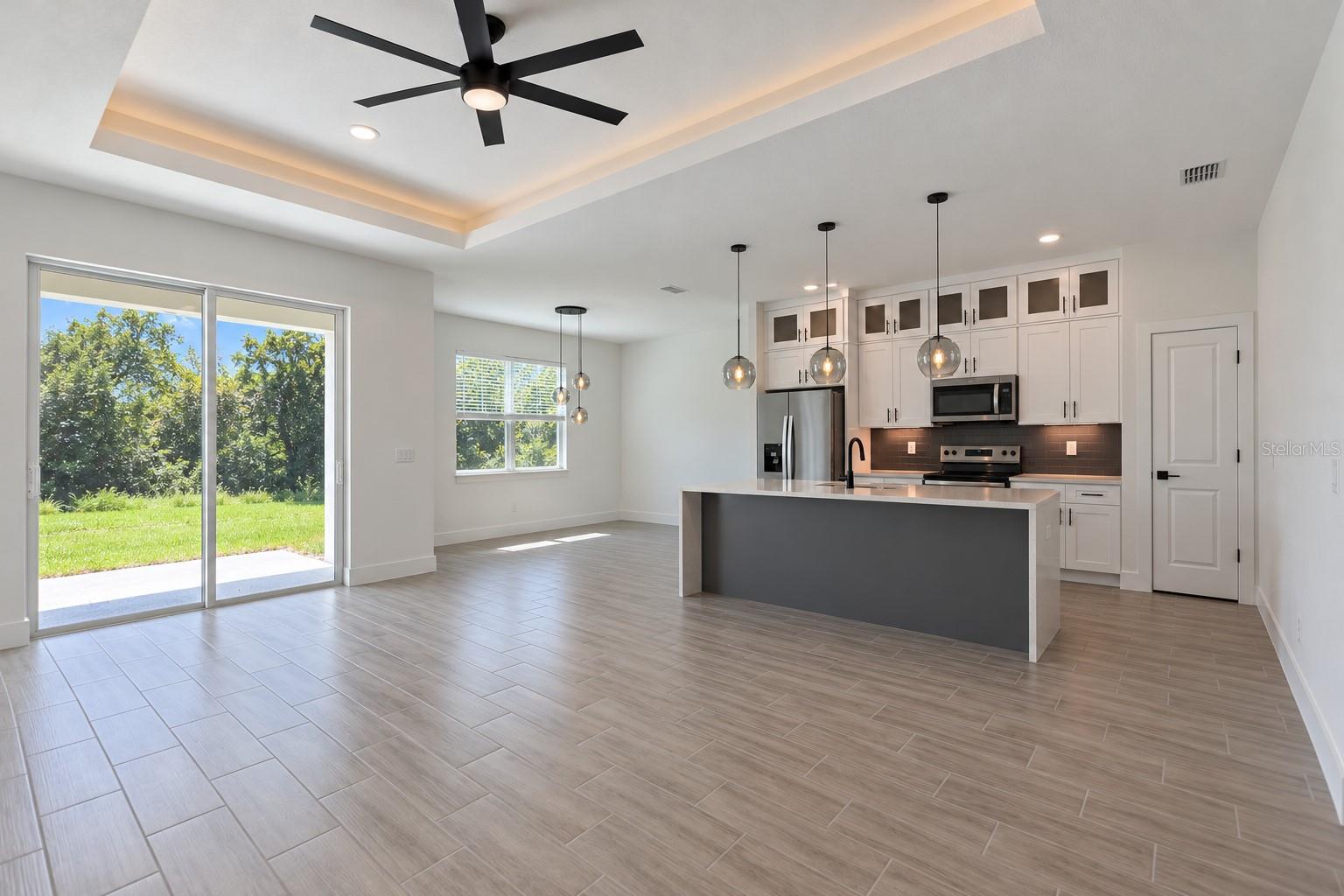 Open living and kitchen. Digitally edited model/property composite.