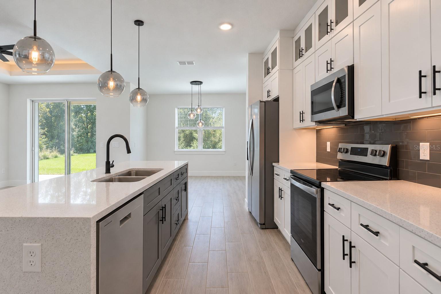 Kitchen reverse view. Digitally edited model/property composite.