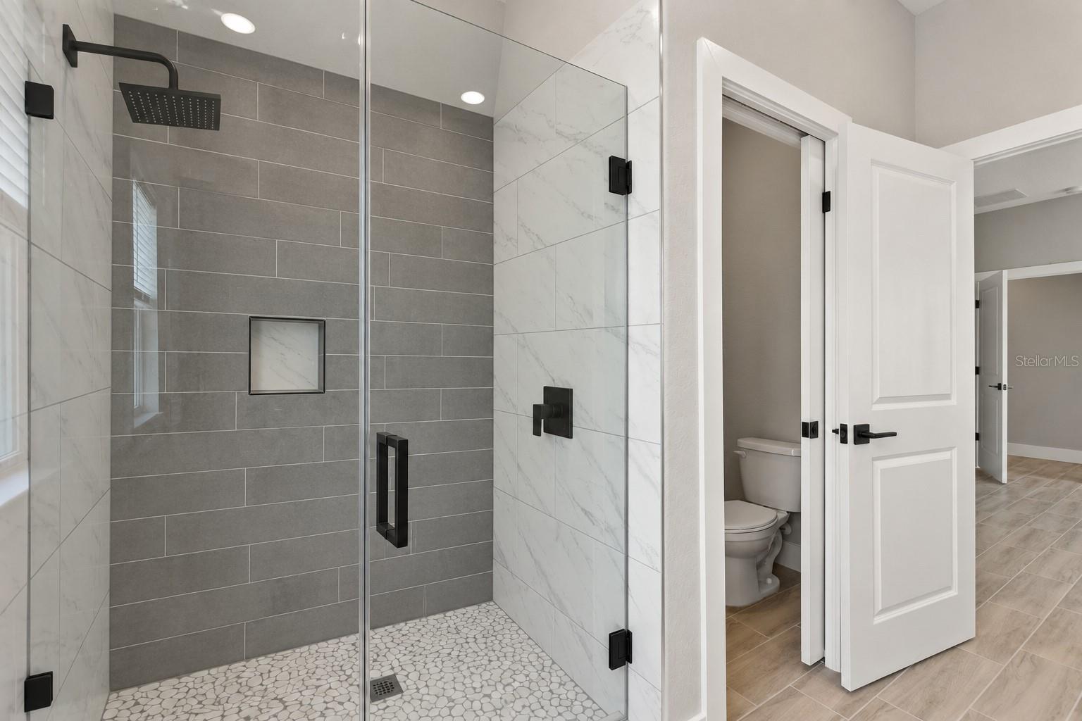Primary shower. Digitally edited model/property composite.