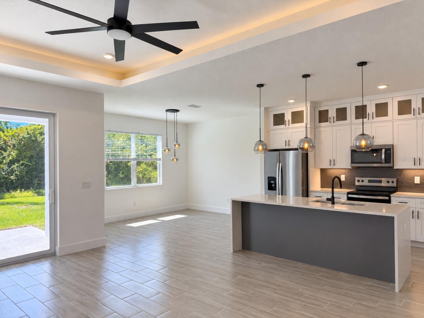 Kitchen and dining connection. Actual property photo, digitally refined.