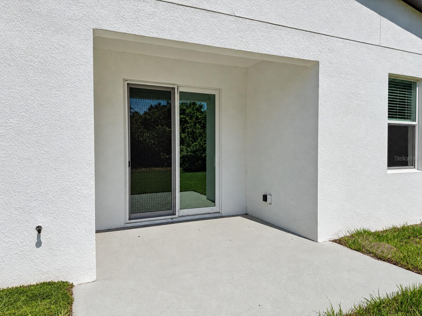 Covered patio. Actual property photo, digitally refined.