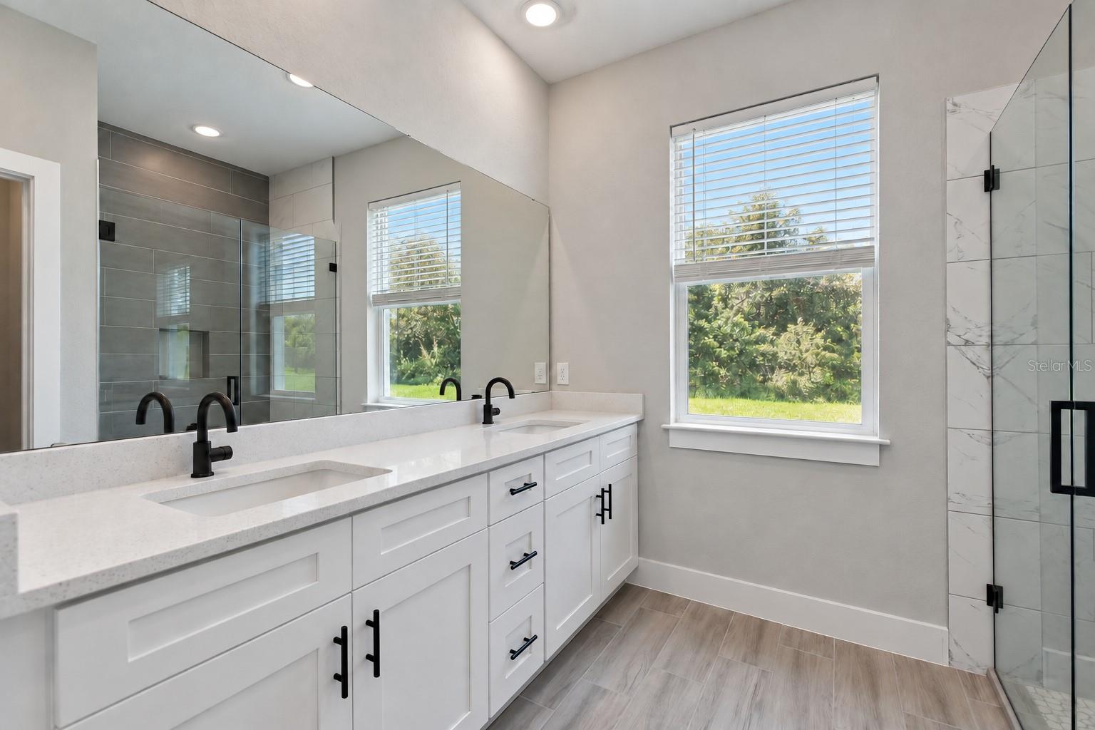 Primary bathroom. Digitally edited model/property composite.