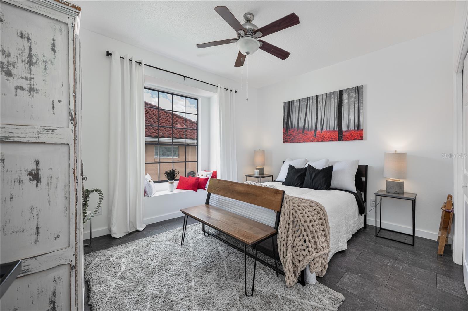 The charming window seat in this secondary bedroom is the perfect spot to read a book.