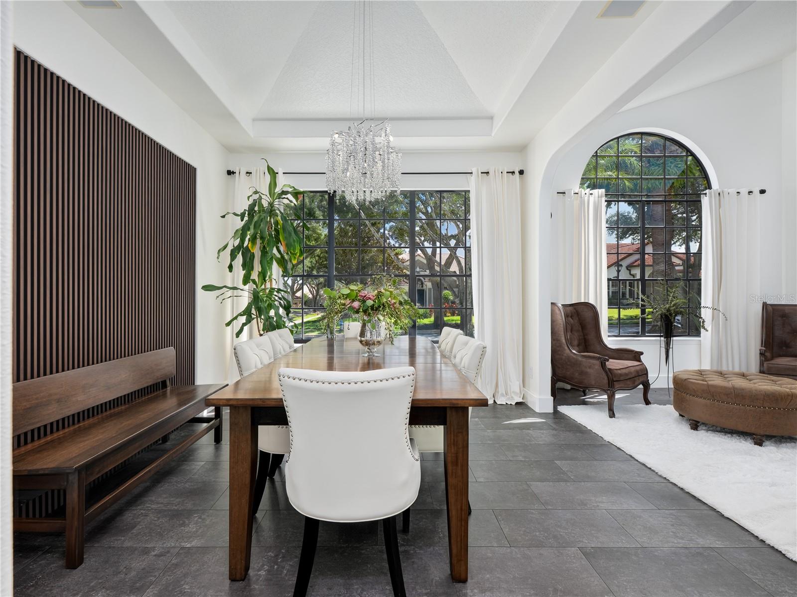 Architectural wood panels serve as the perfect backdrop for this stunning dining room.