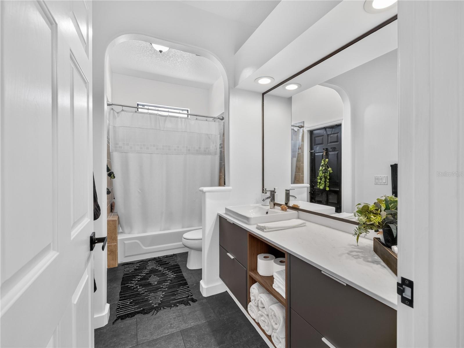 The third full bath is conveniently located near the second and third bedrooms.