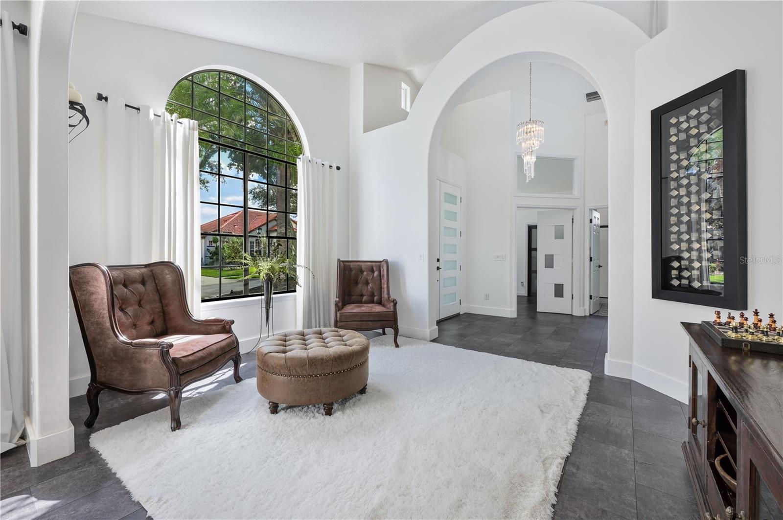 This formal living room is a standout feature of the home, providing an elegant space for relaxation and the perfect backdrop for a holiday tree.