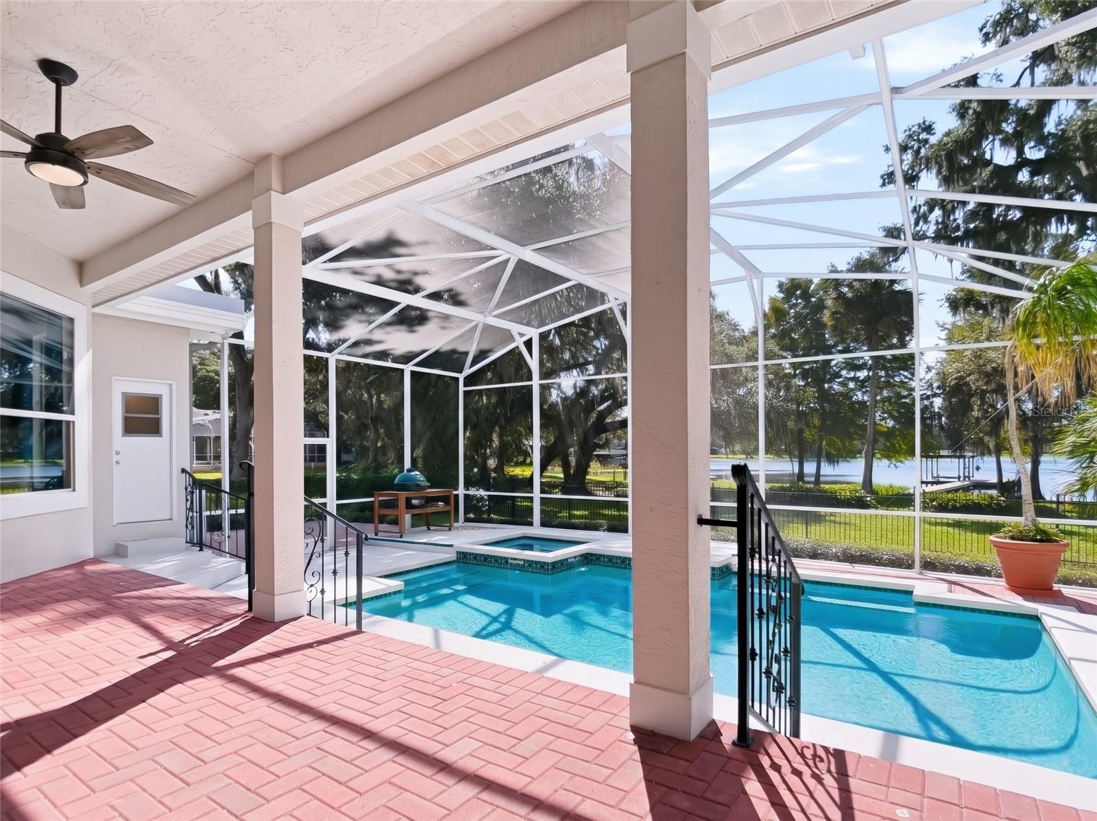 Elevated brick porch with pool and lake views