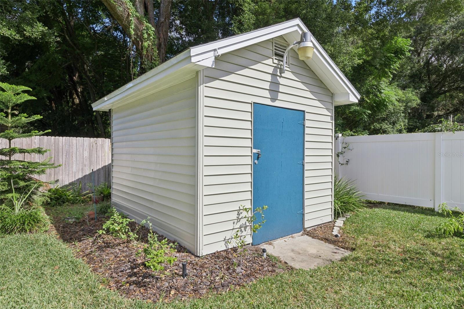 Workshop / Shed.  with an irrigation well and 4 zone sprinkler set up behind.