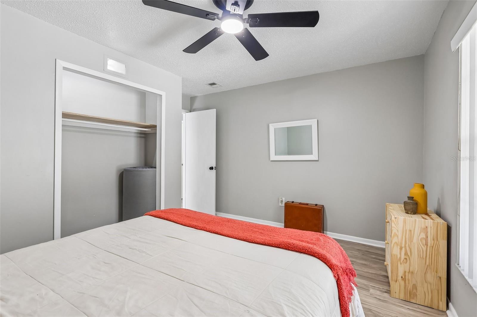 Guest bedroom 2 features a ceiling fan and built-in closet