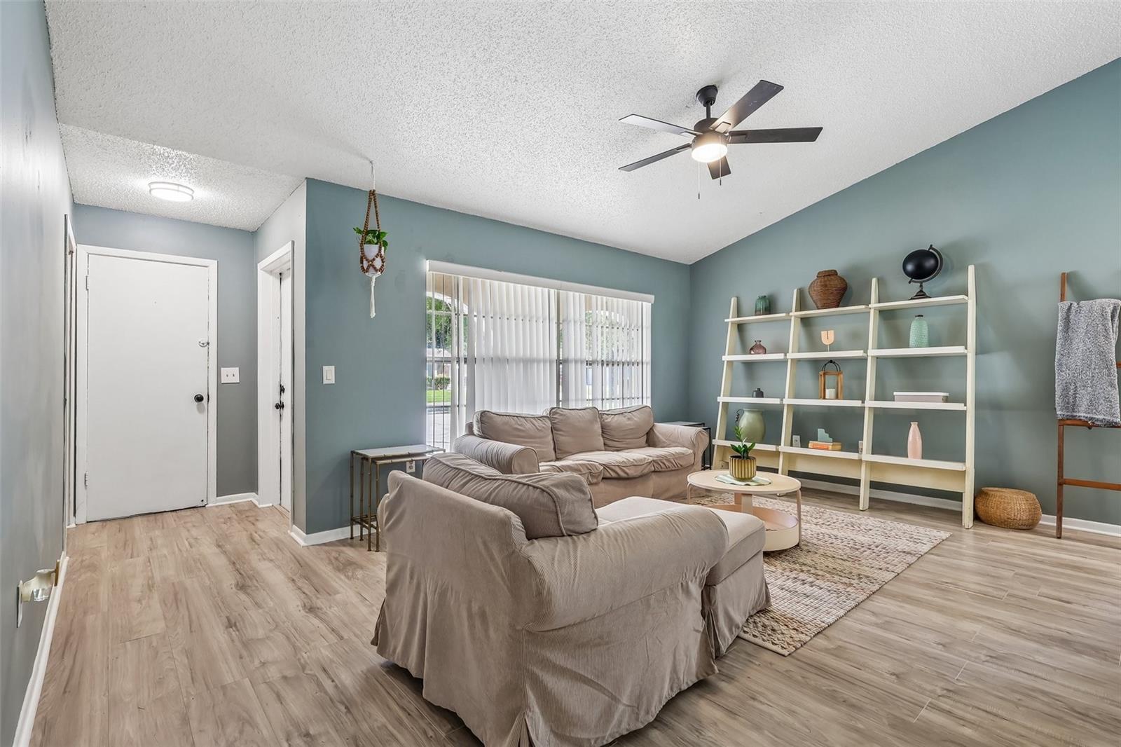 As you enter your new abode, you have a lovely living space with a neutral but bold paint color