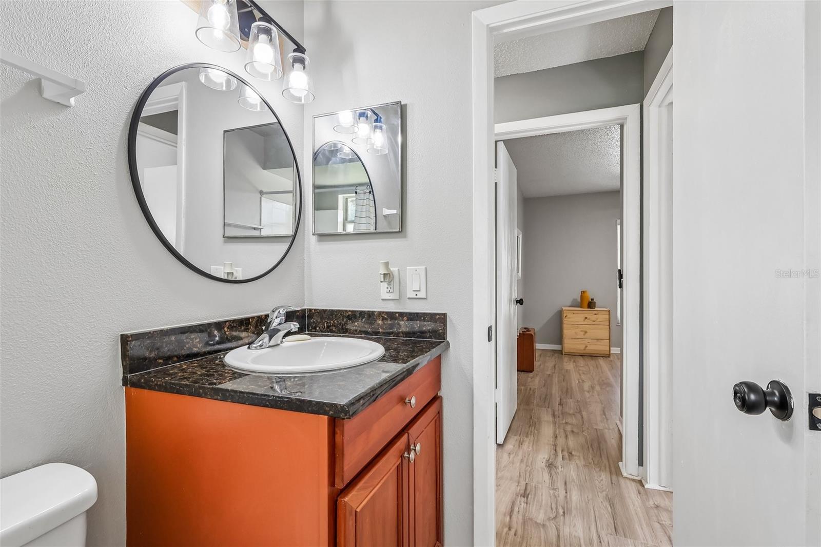 The guest bathroom also has a wall cabinet for extra storage