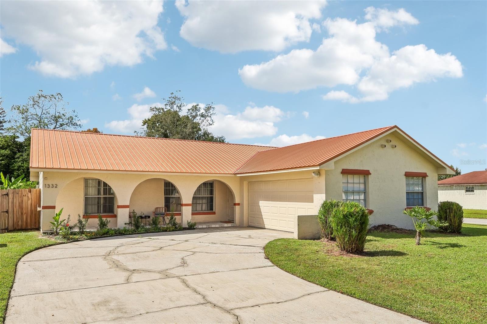 Welcome to your Spanish-Inspired Ranch home! You'll love the curved driveway with easy access to your corner lot house and the stylish arches on the patio.