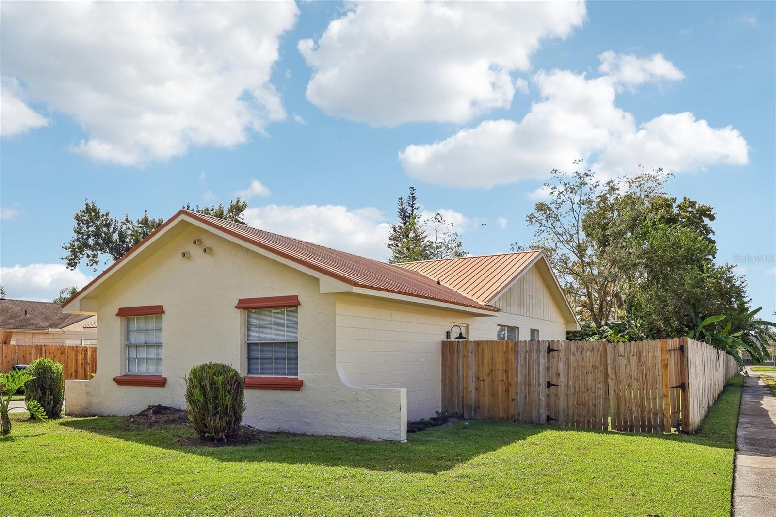 Well maintained lawn and completely wood-fenced yard