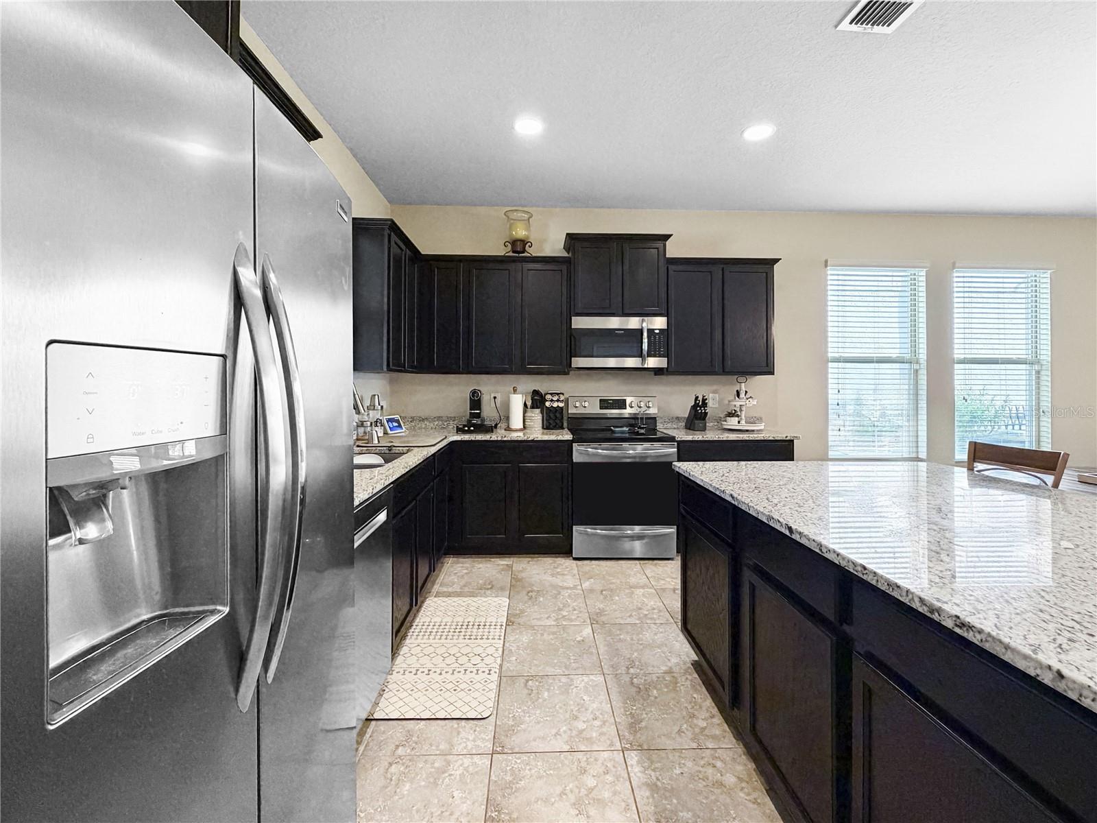 Classic espresso cabinetry, granite counters and stainless appliances