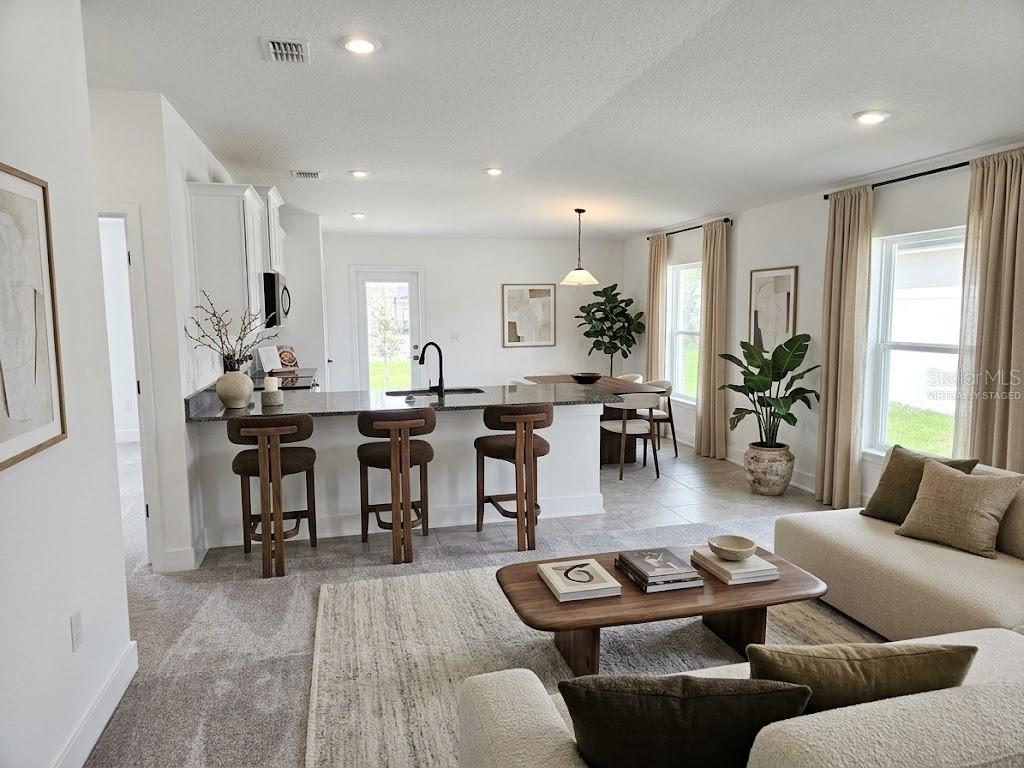 Great room and kitchen - virtually staged Great room and kitchen - virtually staged