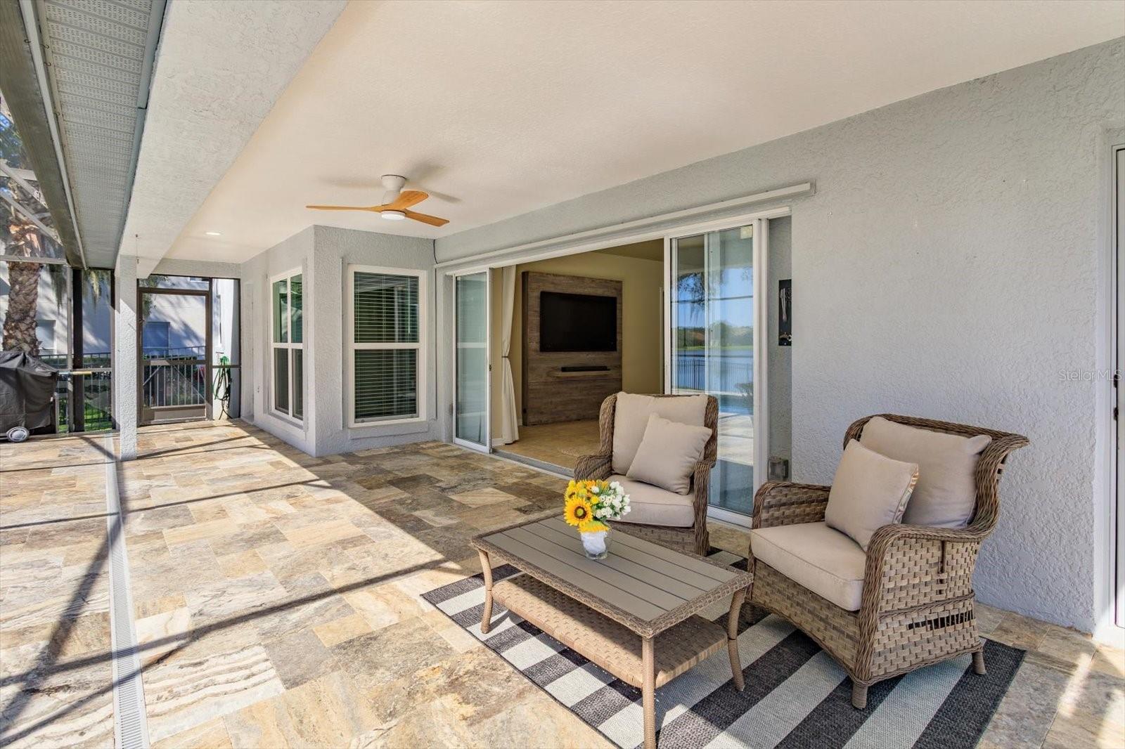 Travertine covered porch with double pocket sliding doors