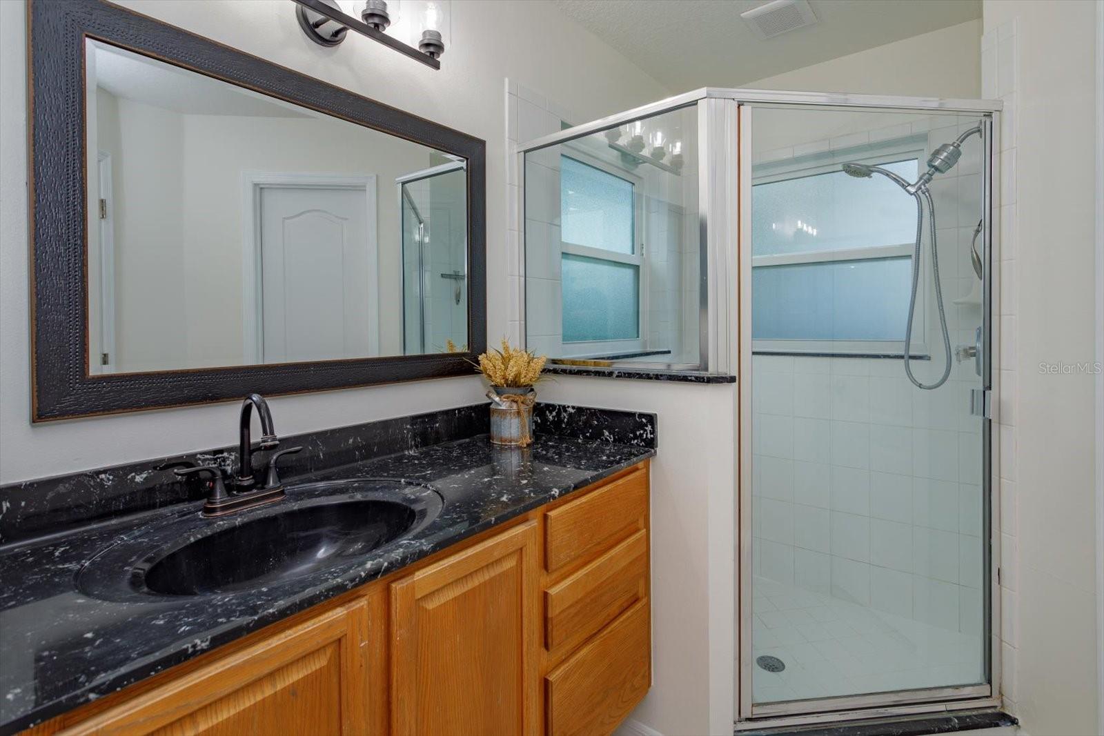 His primary bathroom features walk in shower and private water closet