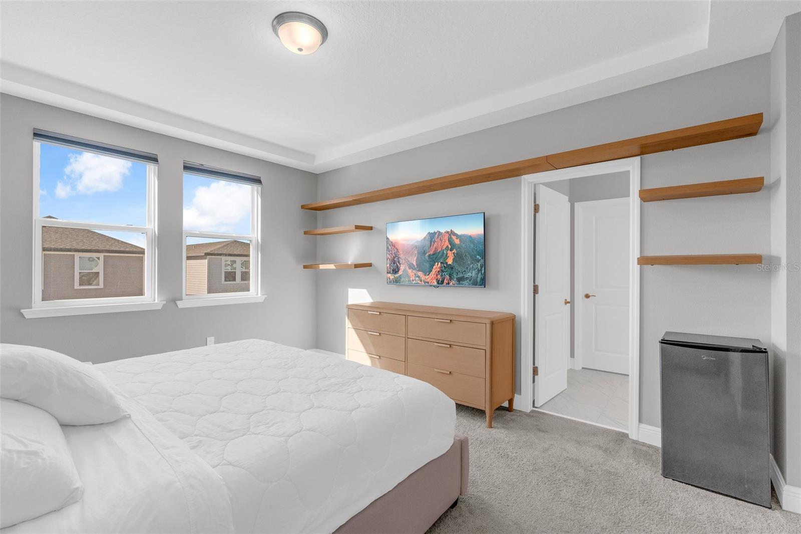 Primary bedroom with access to the en-suite bathroom