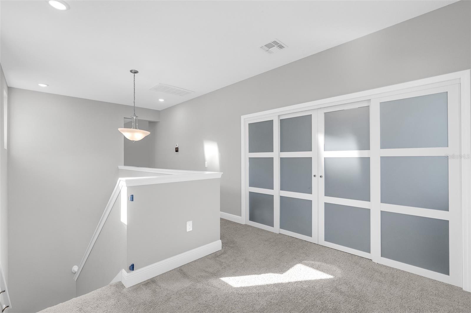 Sliding doors connecting the loft and upstairs landing