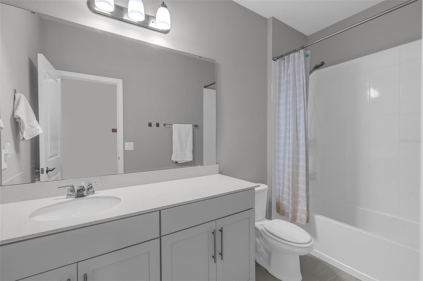 Full bathroom with vanity and tub/shower combination