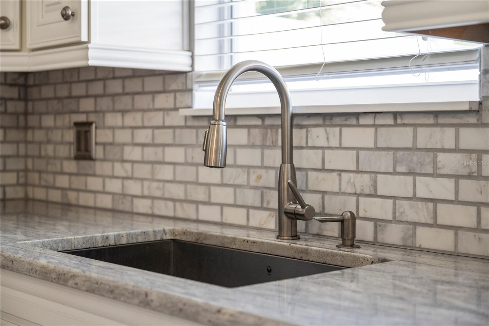 Kitchen sink overlooking courtyard patio
