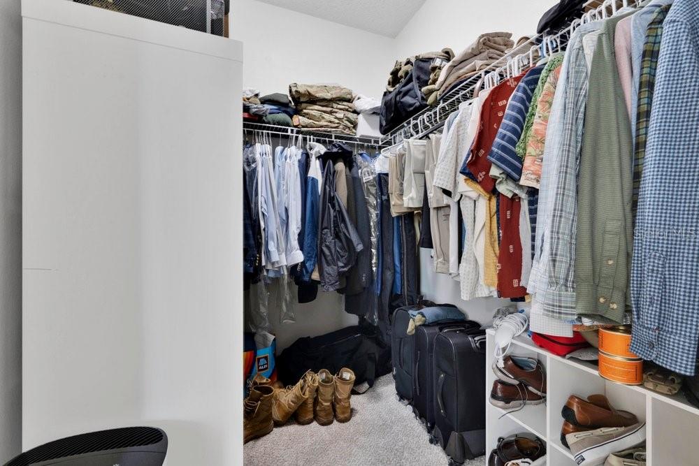 Primary bedroom walk-in closet 1 of 2