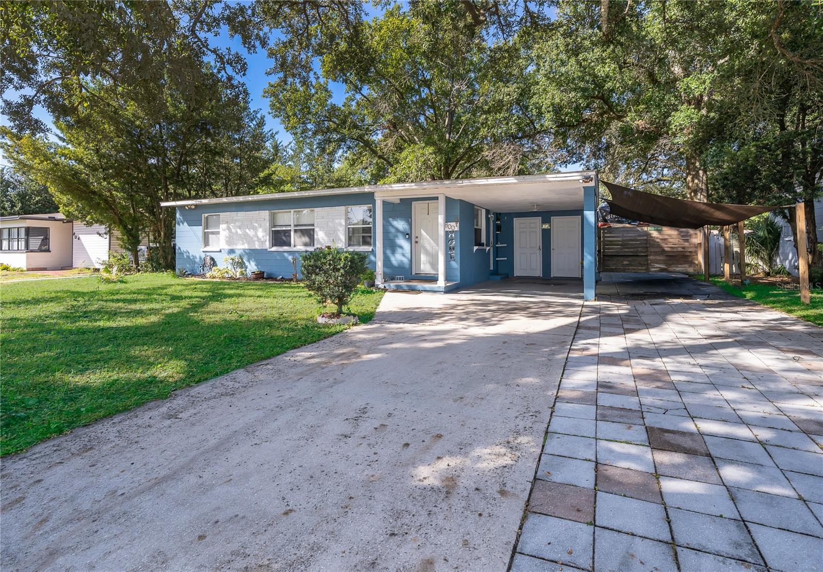 A welcoming driveway leads you to this charming home, surrounded by established landscaping and beautiful greenery.