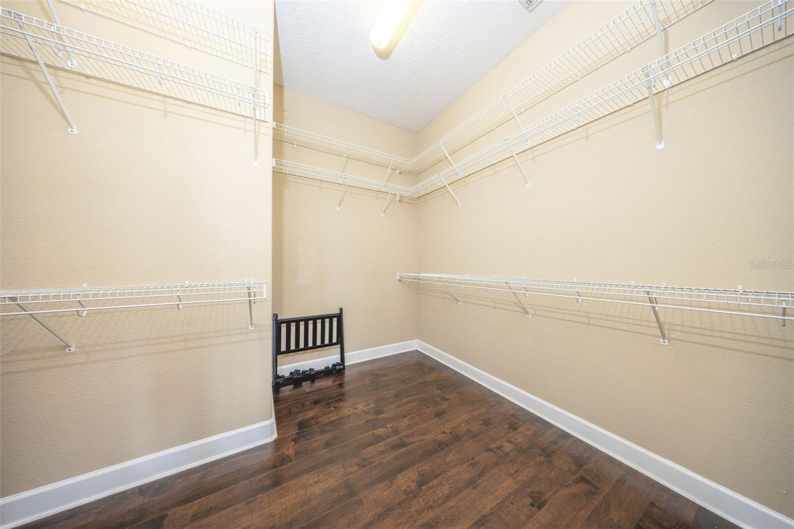 Primary bedroom walk-in closet