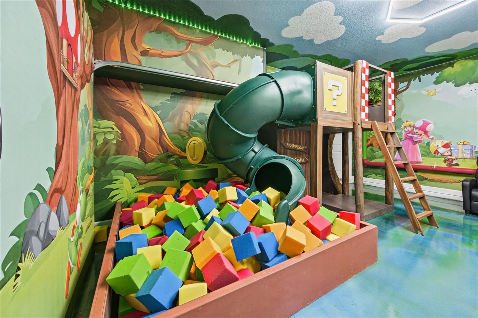 Game room slide and foam pit