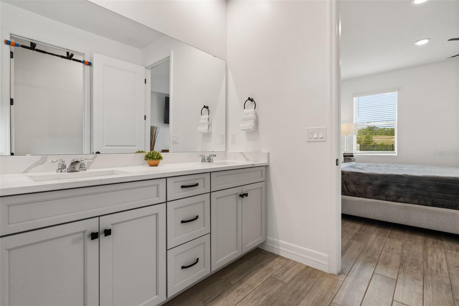 Primary bathroom at rear of home with view of greenbelt