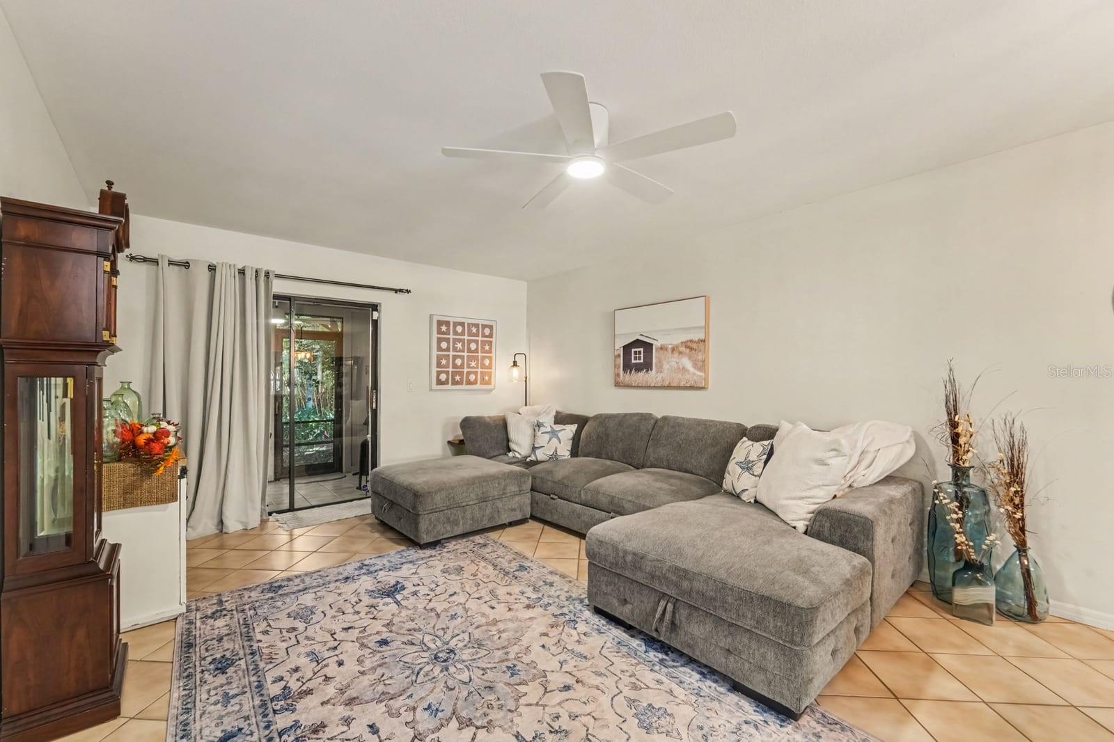 Spacious Living Area Opens to Screened Porch with Comfortable Seating Spacious Living Area Opens to Screened Porch with Comfortable Seating