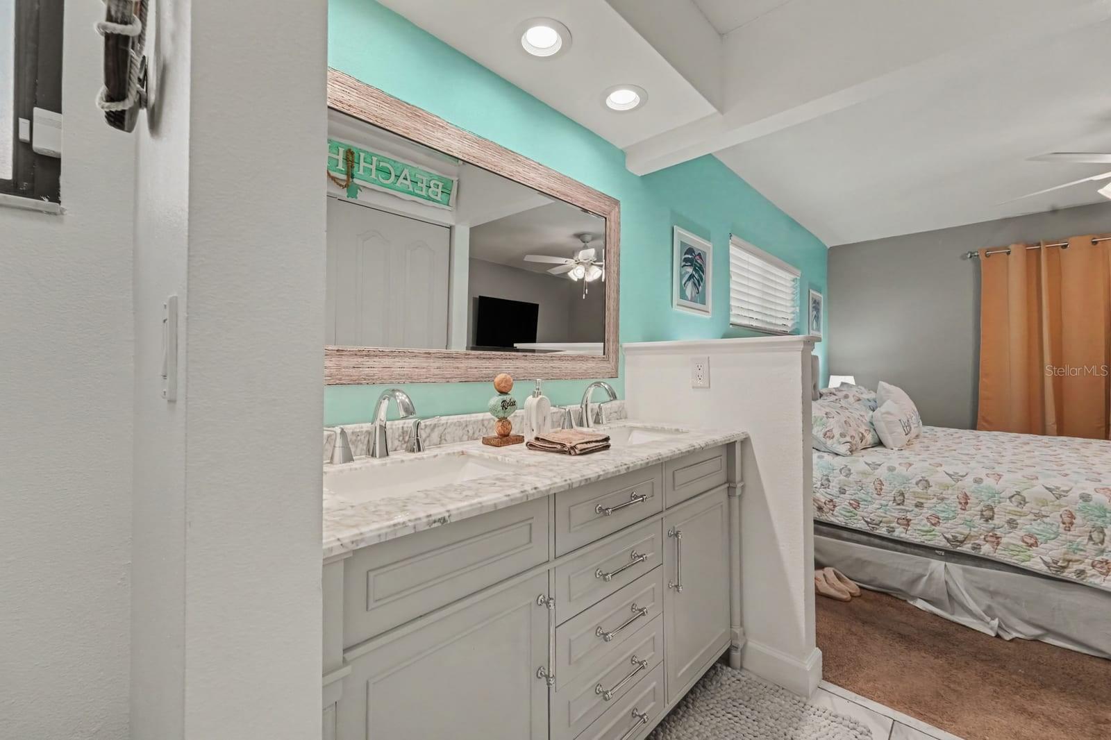 Luxurious spa-style ensuite with dual vanity, marble counters, and walk-in shower