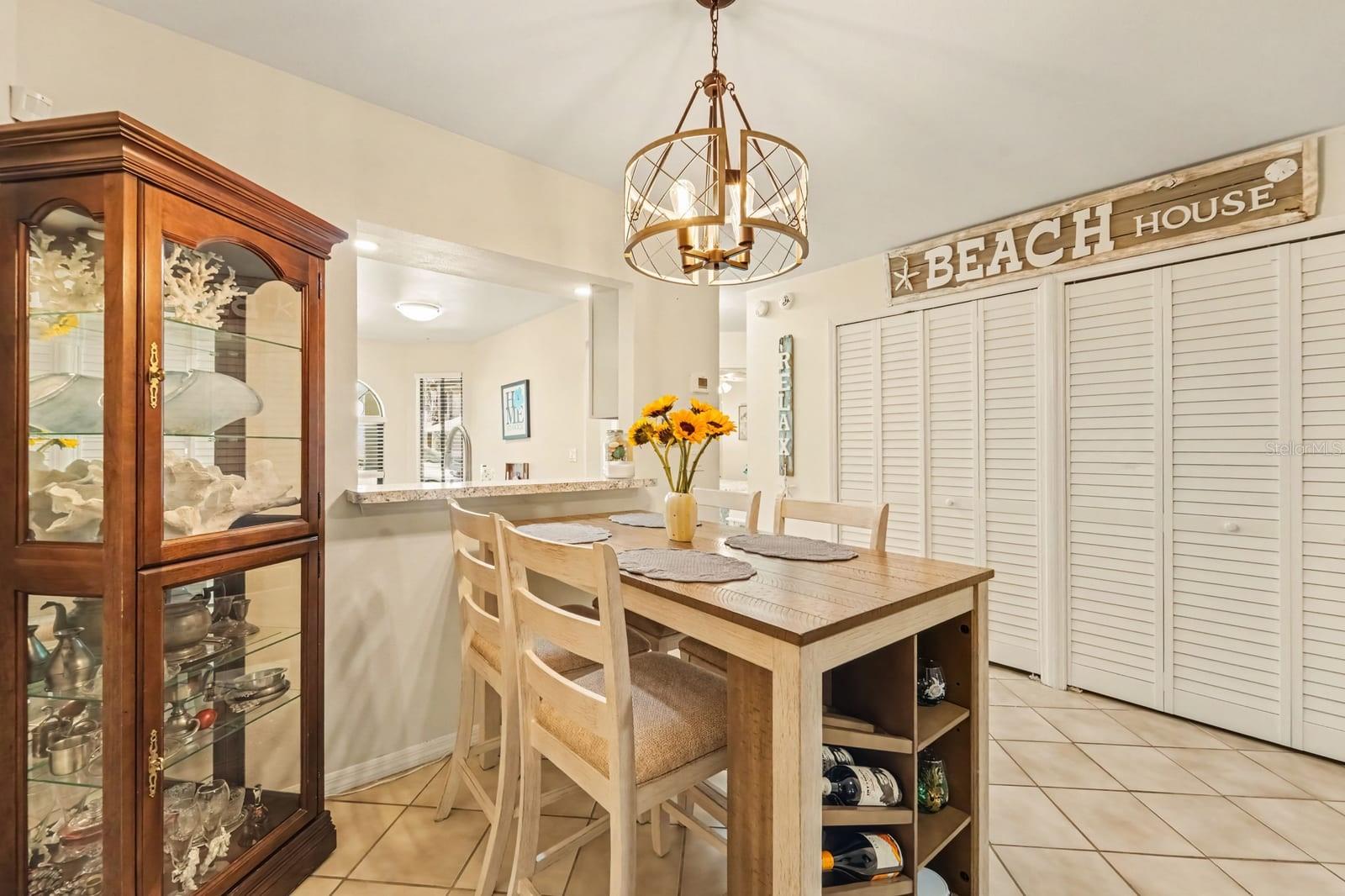 Elegant Dining Area with Island Storage and Pendant Lighting Elegant Dining Area with Island Storage and Pendant Lighting