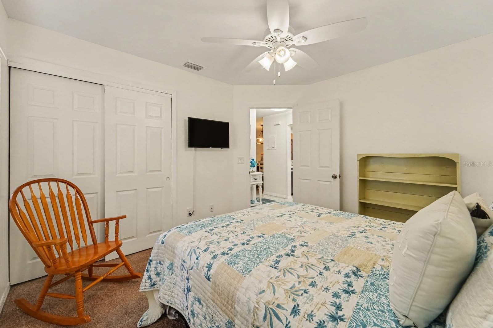 Guest Bedroom with Dual Closets and Comfortable Furnishings