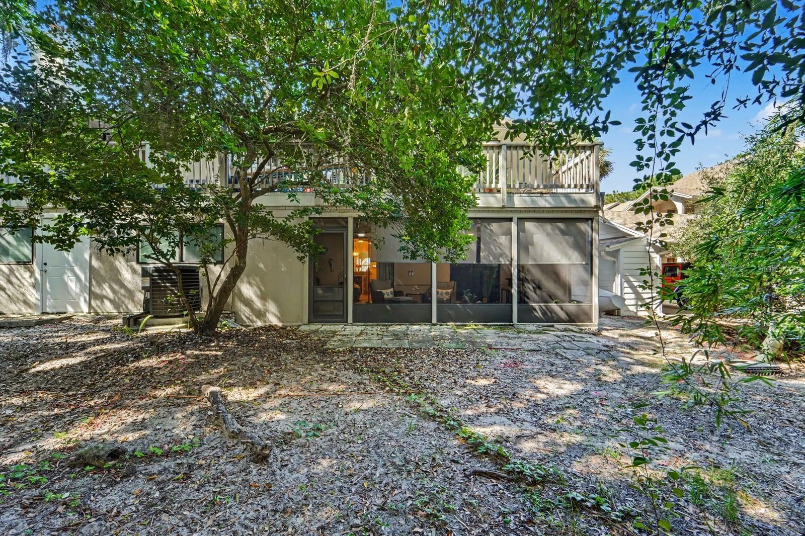 Shaded Rear Courtyard With Modern Screened Patio and Mature Trees