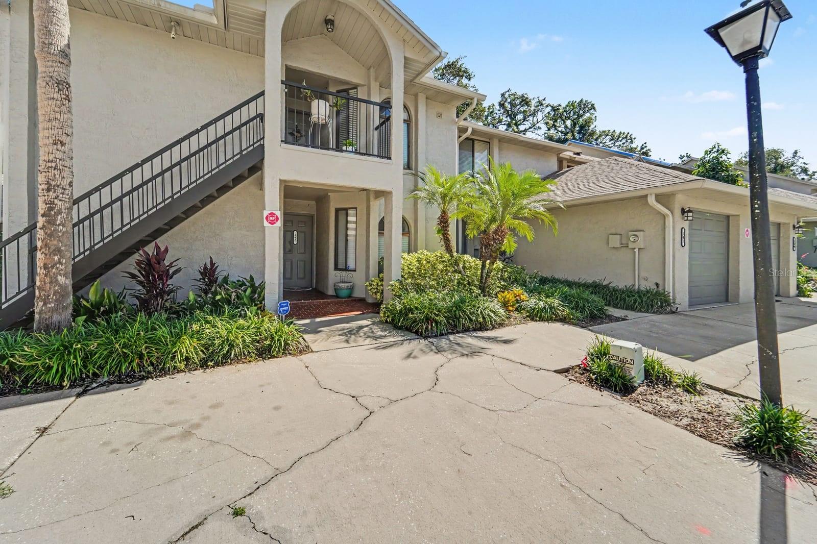 Elevated Entry with Black Railing and Lush Landscaping Frame Home Entrance Elevated Entry with Black Railing and Lush Landscaping Frame Home Entrance