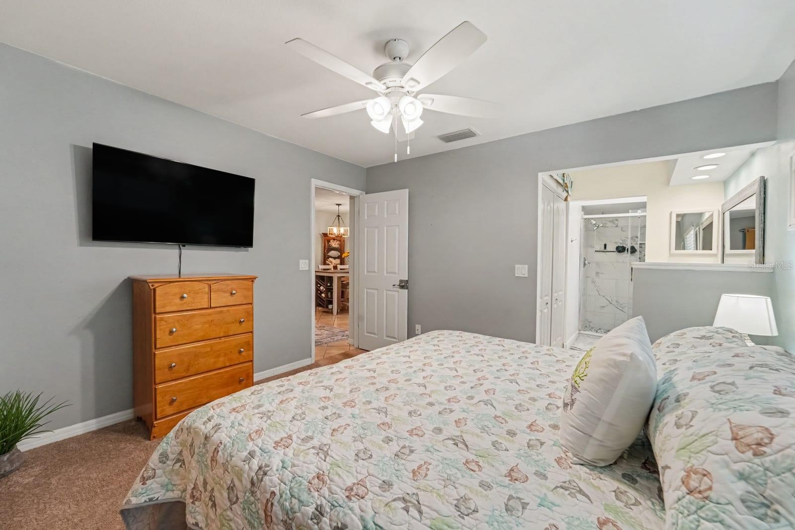 Spacious secondary bedroom with dual beds, walk-in closet, and ensuite bathroom access
