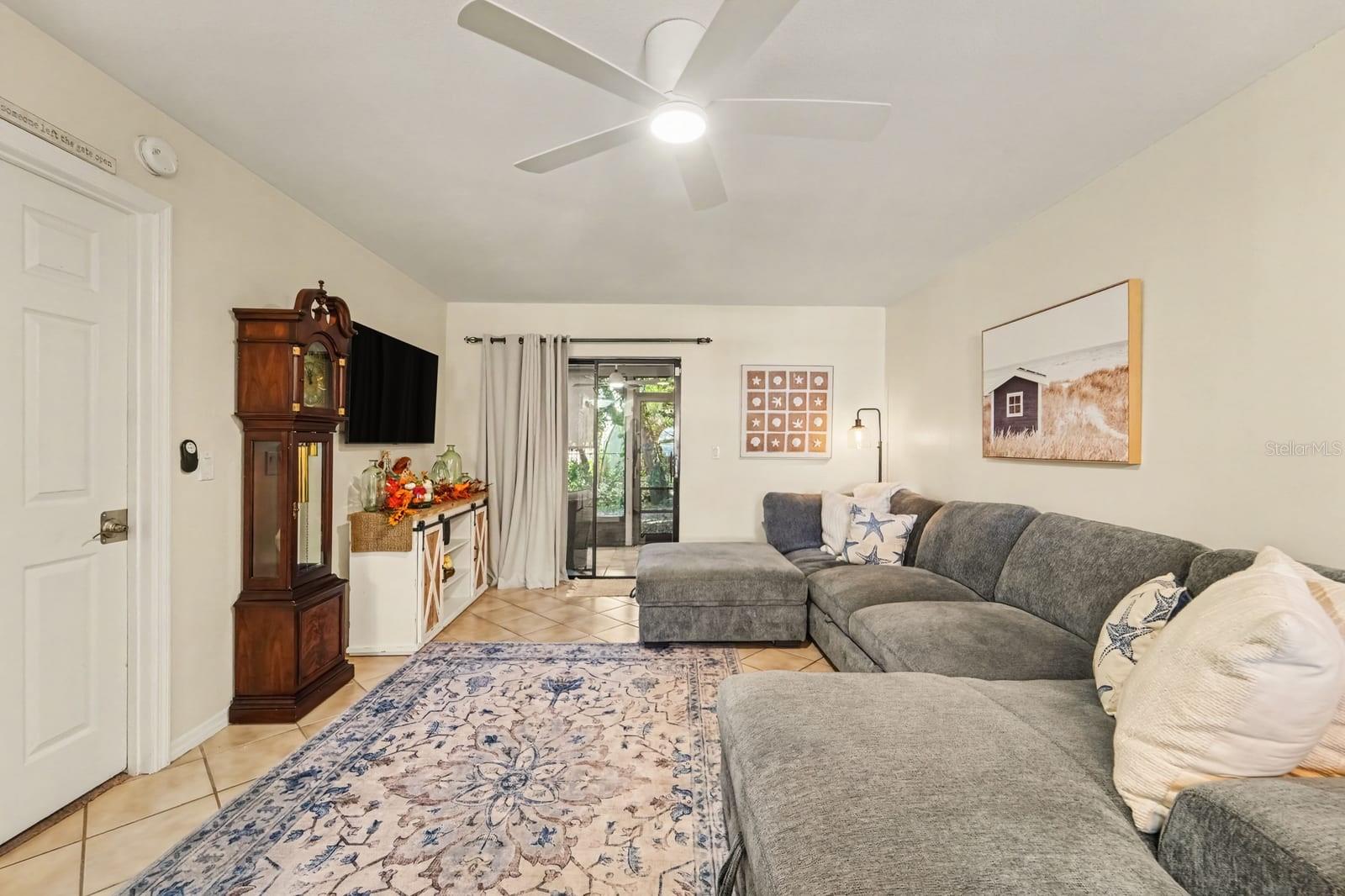 Bright Living Space Features Sectional Sofa and Patio Door with Greenery Views Bright Living Space Features Sectional Sofa and Patio Door with Greenery Views